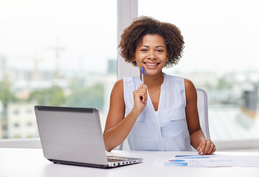 Happy African Woman with Laptop at Office